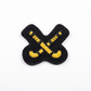 Black and yellow embroidered patch on a white background