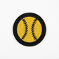 Embroidered patch of a softball with yellow background and black stitching on a white background