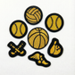Set of sports-themed patches including basketball, baseball, softball, and bowling ball on a white background.