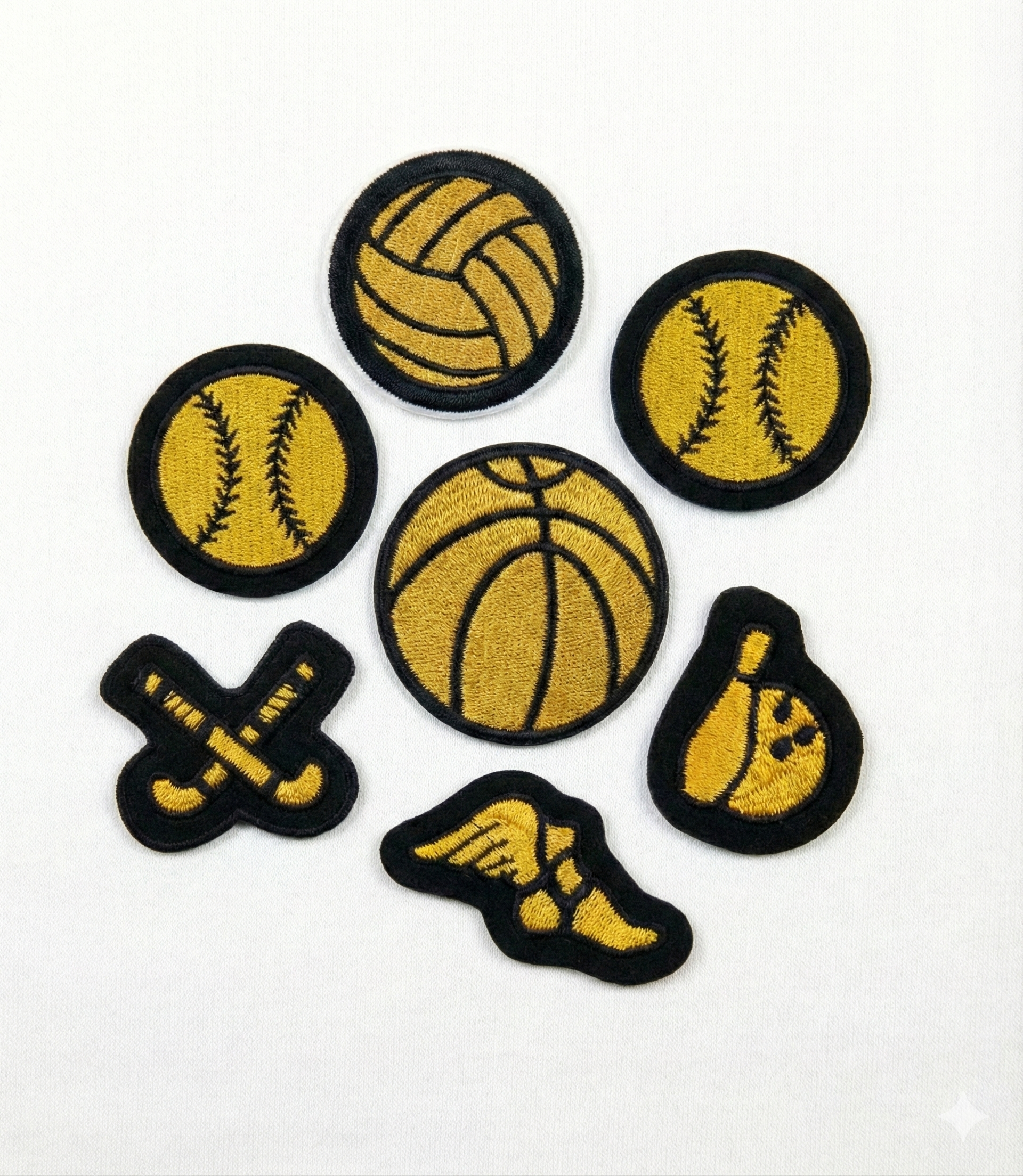 Set of sports-themed patches including basketball, baseball, softball, and bowling ball on a white background.